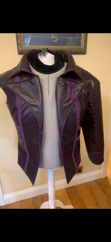 A purple and black leather jacket displayed on a mannequin against a neutral background.