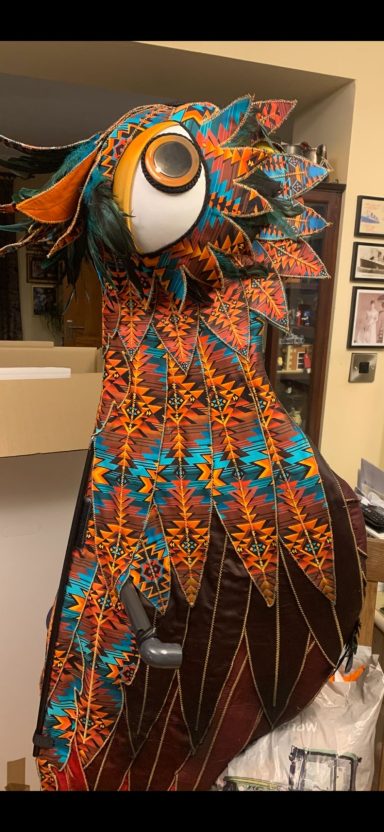 Entertainment Venues Colourful owl costume with intricate patterns and a large eye.