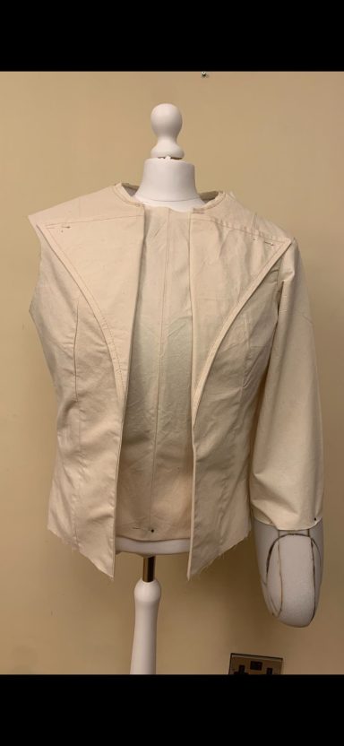 Cream-coloured jacket displayed on a mannequin against a plain backdrop.